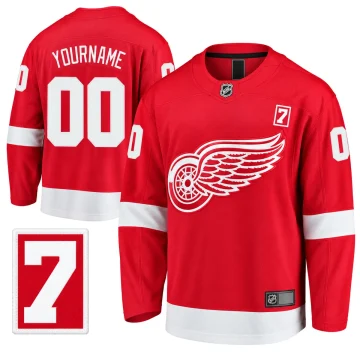 Detroit Red Wings red home YOURNAME 00 custom jersey, upright front and back with matching Ted Lindsay number 7 patch inset on pure white.